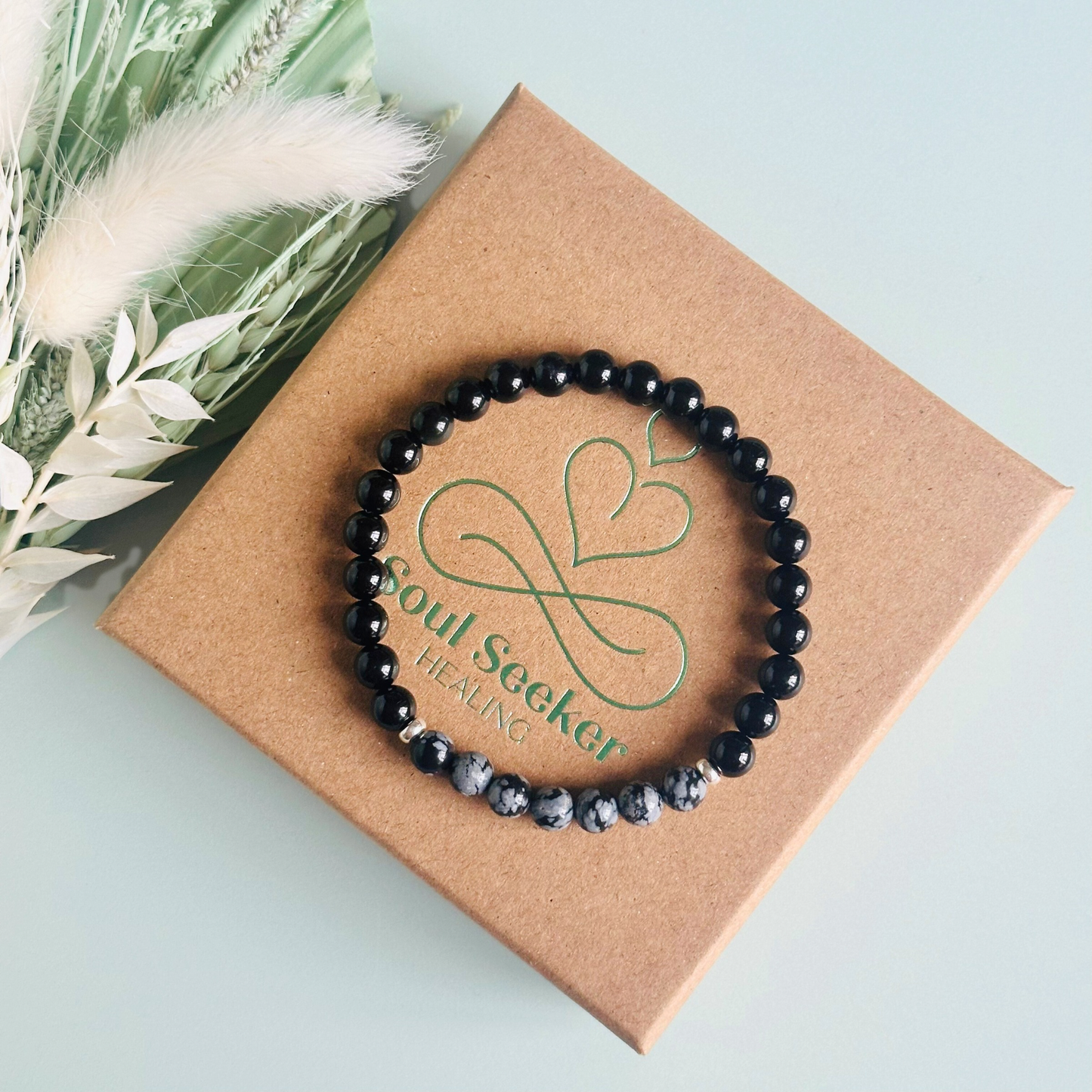 Men’s crystal bracelet featuring 6mm black tourmaline beads, 6mm snowflake obsidian beads with sterling silver spacer beads.