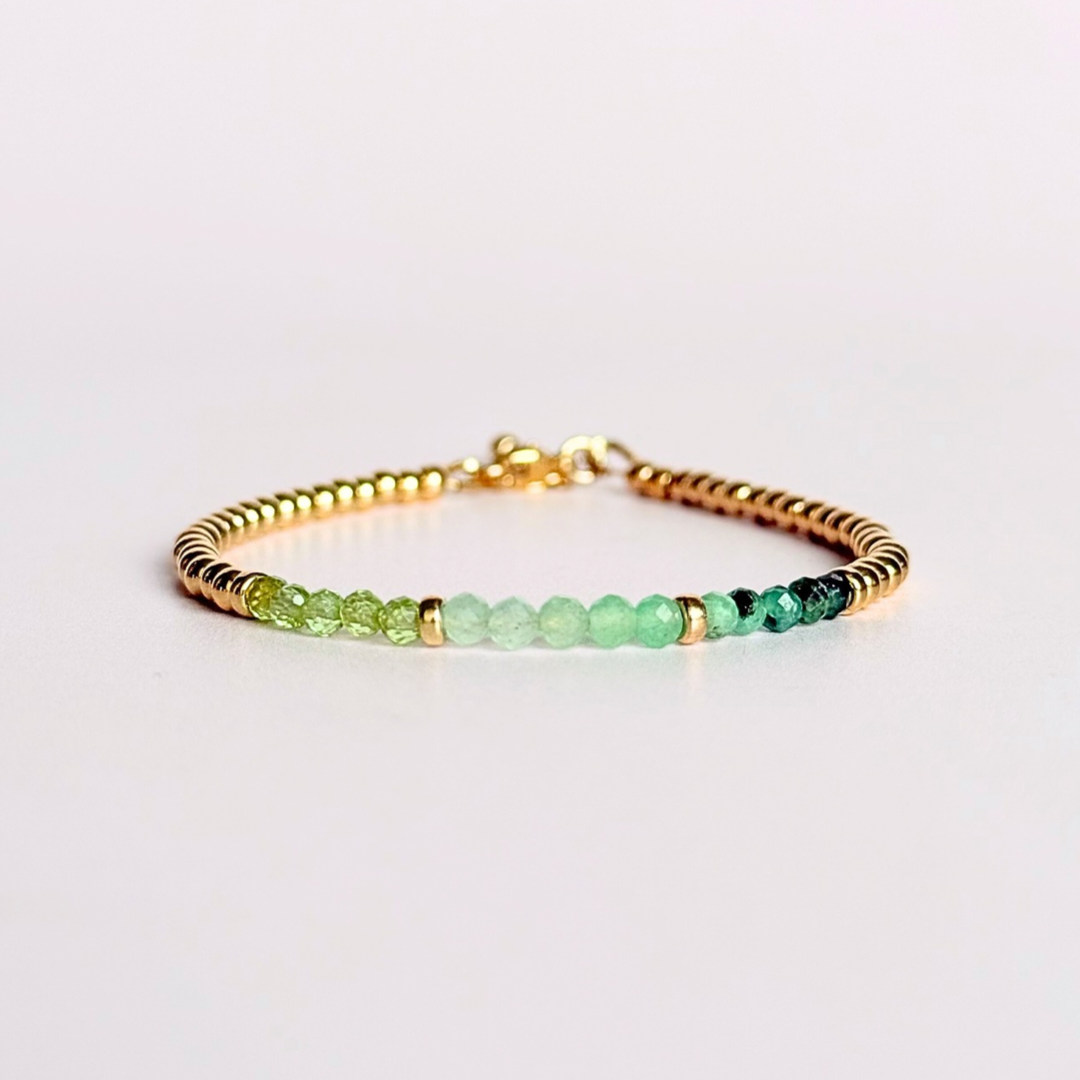 Dainty minimalist yellow gold filled crystal bracelet featuring 3mm faceted emerald, peridot and green aventurine beads in a colour block Ombre style. Fastens with a gold filled lobster clasp with an extender chain.