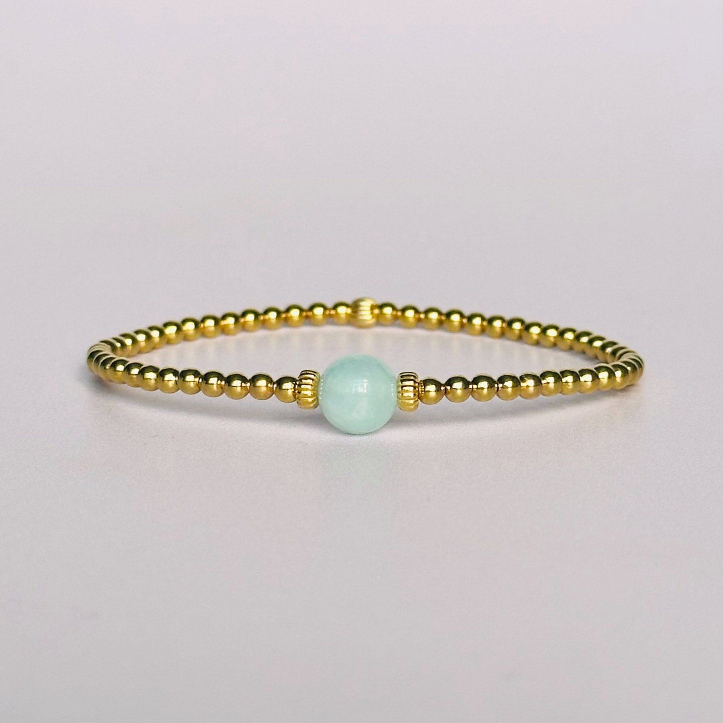 Gold vermeil aquamarine bracelet features an ethically mined 8mm aquamarine bead, flanked by corrugated rondelle beads on a band of 3mm gold vermeil beads. A bracelet to promote courage and self expression.
