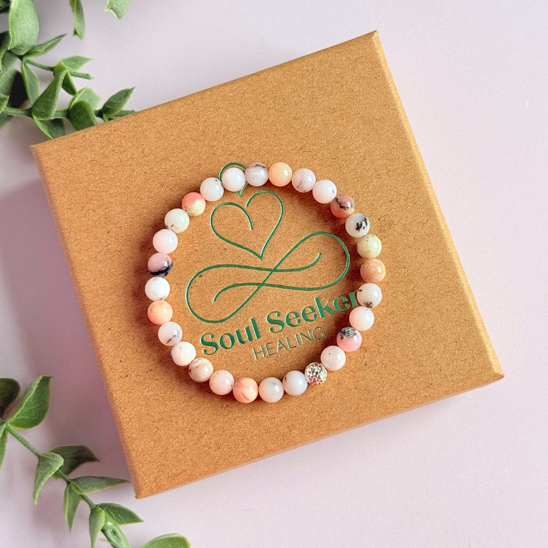 Pink opal bracelet featuring 6mm genuine round pink opal beads, with one faceted gold vermeil 6mm bead as the focal point. Elasticated for comfort.
