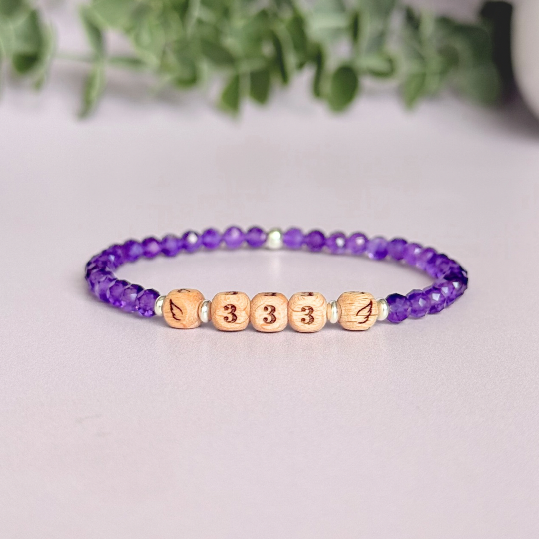 Bracelet featuring engraved wooden 333 angel number and wing beads, on the band of 4mm faceted amethyst round crystal gemstone beads. Finished with your choice of gold vermeil, sterling silver or rose gold vermeil accent beads.