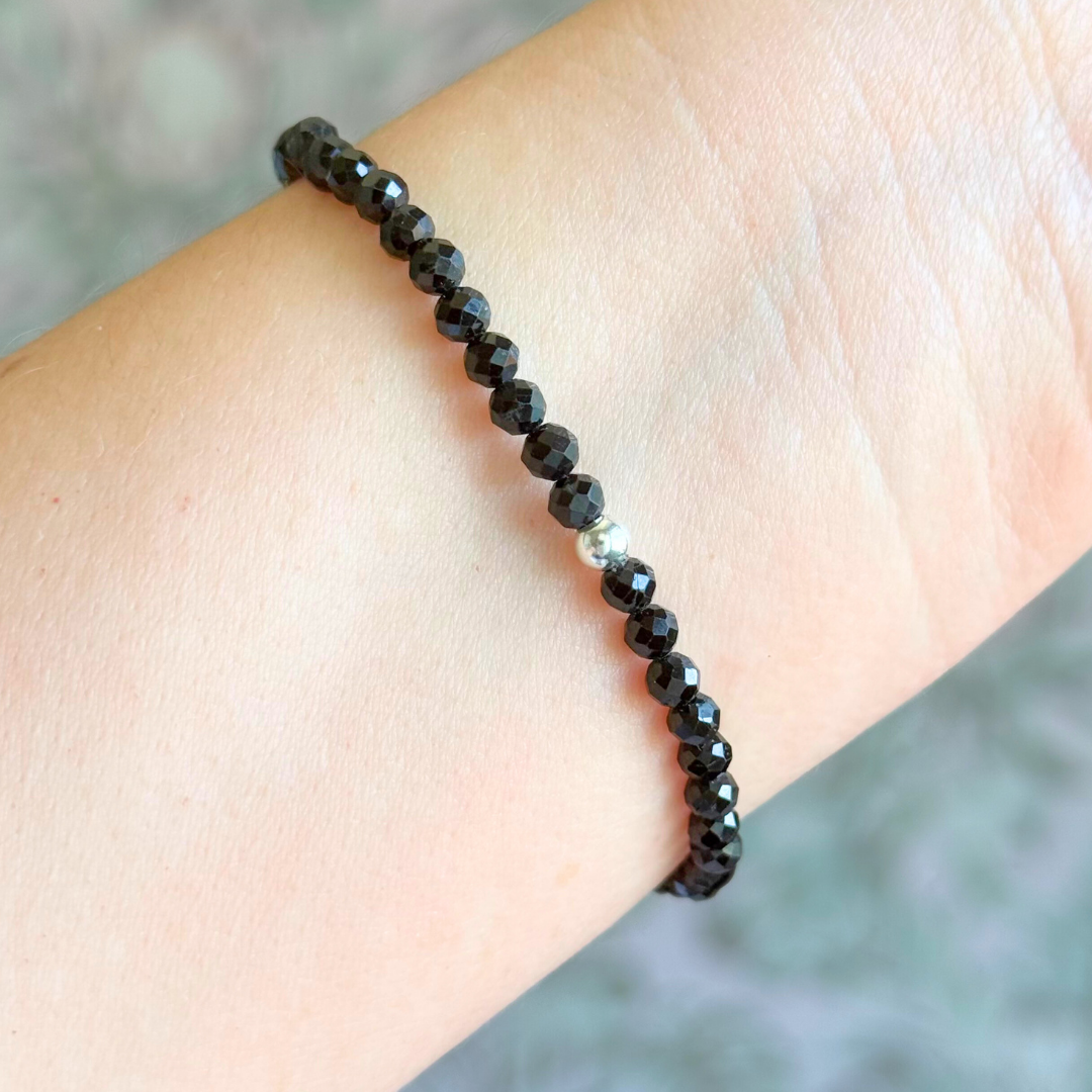 Bracelet featuring engraved wooden 444 angel number and wing beads, on the band of 4mm faceted black tourmaline round crystal gemstone beads. Finished with your choice of gold vermeil, sterling silver or rose gold vermeil accent beads.