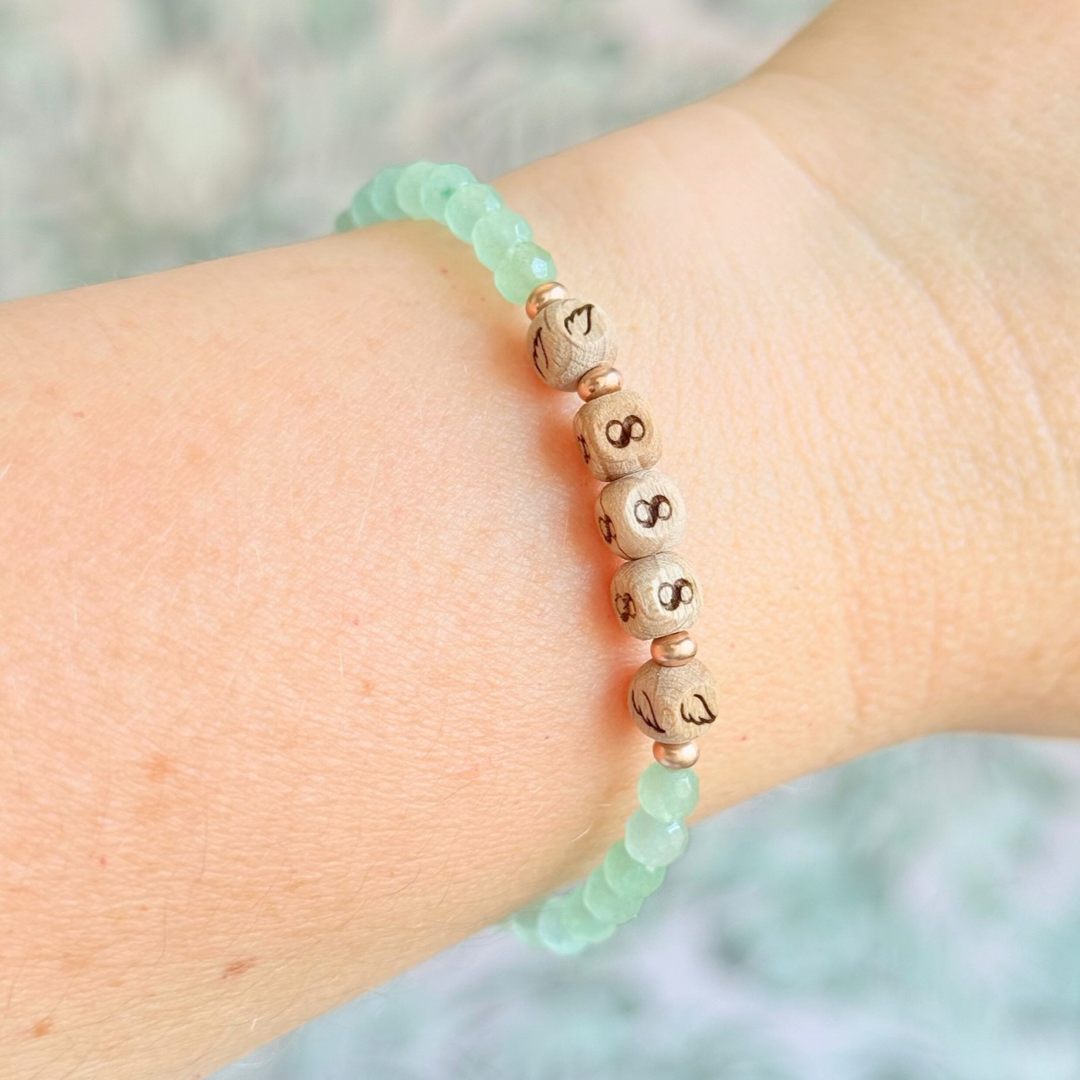 Bracelet featuring engraved wooden 888 angel number and wing beads, on the band of 4mm faceted green aventurine round crystal gemstone beads. Finished with your choice of gold vermeil, sterling silver or rose gold vermeil accent beads.
