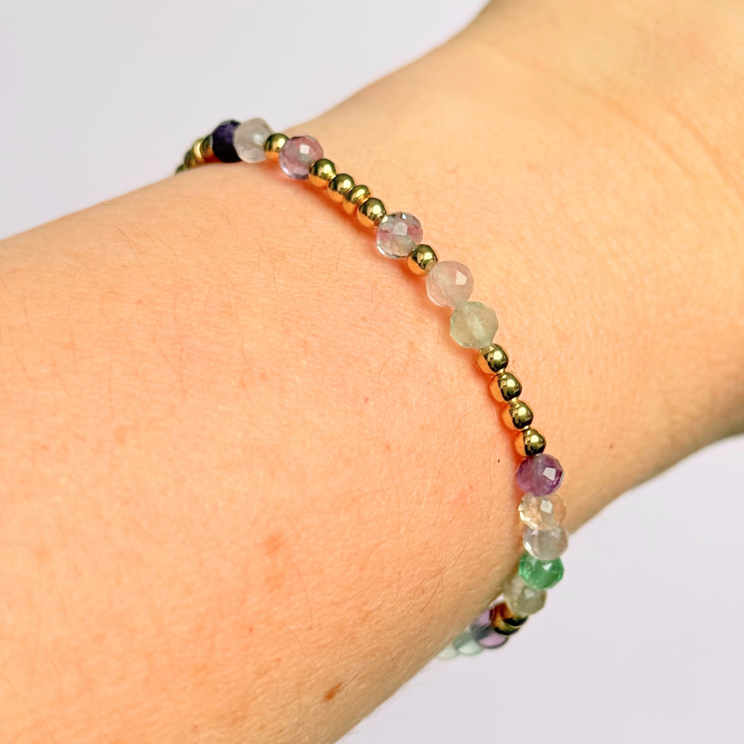 Elasticated stretch fluorite crystal morse code bracelet spelling out the words ‘ADHD and awesome’ in a combination of 4mm round fluorite beads, 4mm faceted fluorite beads and either sterling silver or gold vermeil 3mm round beads. The words start and end at the rondelle spacer beads.