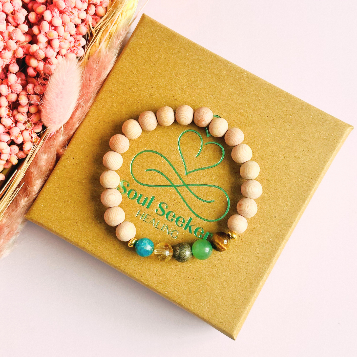 Essential oil diffuser bracelet with five crystals all believed to help with manifestation. Featuring raw rosewood beads to diffuse aromatherapy oils. With apatite, citrine, pyrite, green aventurine and tigers eye. All beads are 8 mm.