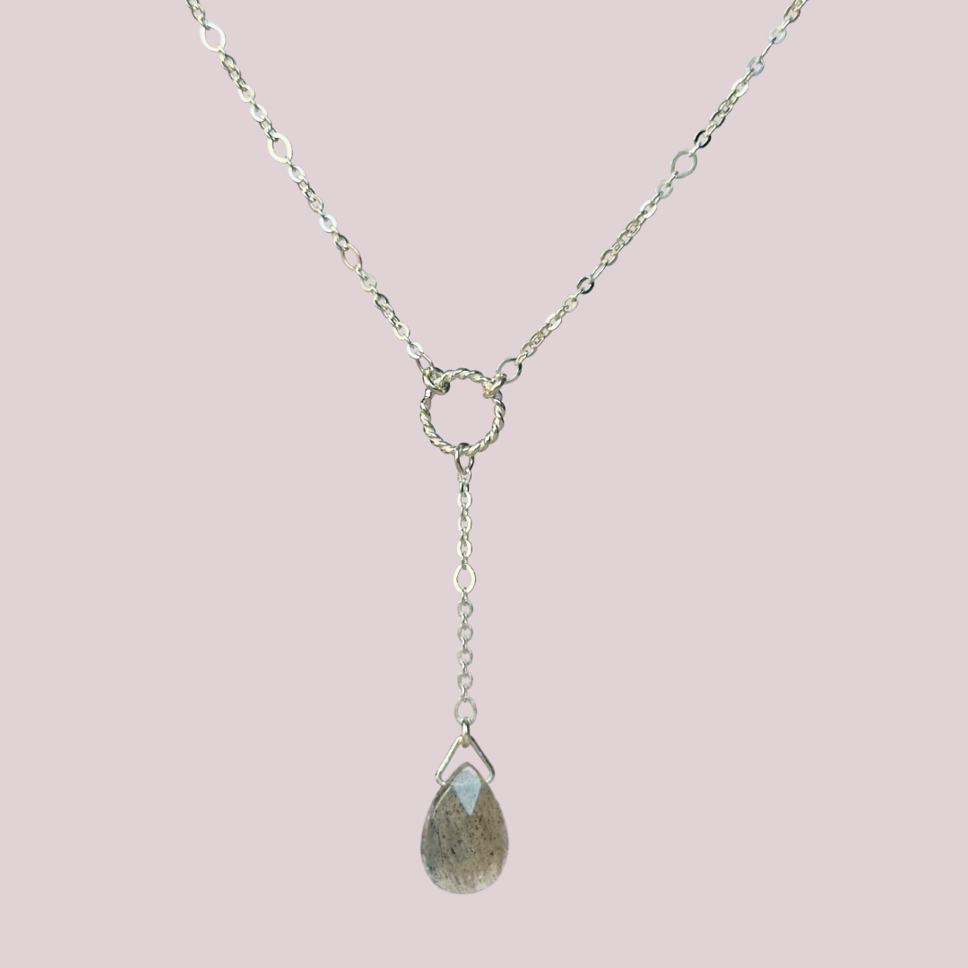 Labradorite necklace featuring a faceted labradorite teardrop bead on a delicate sterling silver chain with a twisted sterling silver ring focal point. The necklace fastens with a subtle yet secure sterling silver bolt clasp. The teardrop bead measures 12mm x 8mm.