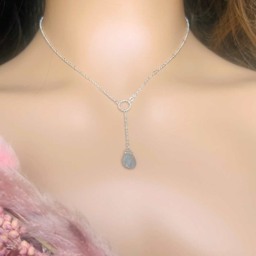 Labradorite necklace featuring a faceted labradorite teardrop bead on a delicate sterling silver chain with a twisted sterling silver ring focal point. The necklace fastens with a subtle yet secure sterling silver bolt clasp. The teardrop bead measures 12mm x 8mm.