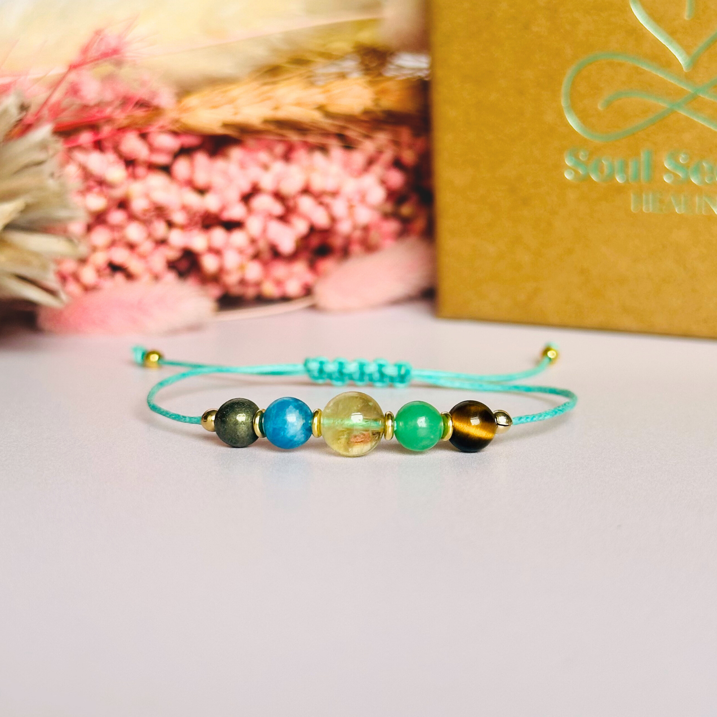 Manifesting crystal healing bracelet made with the tigers eye, green aventurine, citrine, apatite and pyrite. Strung on an eco and vegan friendly waxed cotton cord and finished with your choice of sterling silver, rose gold vermeil or gold vermeil accent beads. A sliding macramé clasp makes it adjustable.