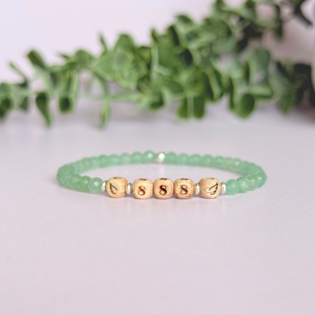 Bracelet featuring engraved wooden 888 angel number and wing beads, on the band of 4mm faceted green aventurine round crystal gemstone beads. Finished with your choice of gold vermeil, sterling silver or rose gold vermeil accent beads.