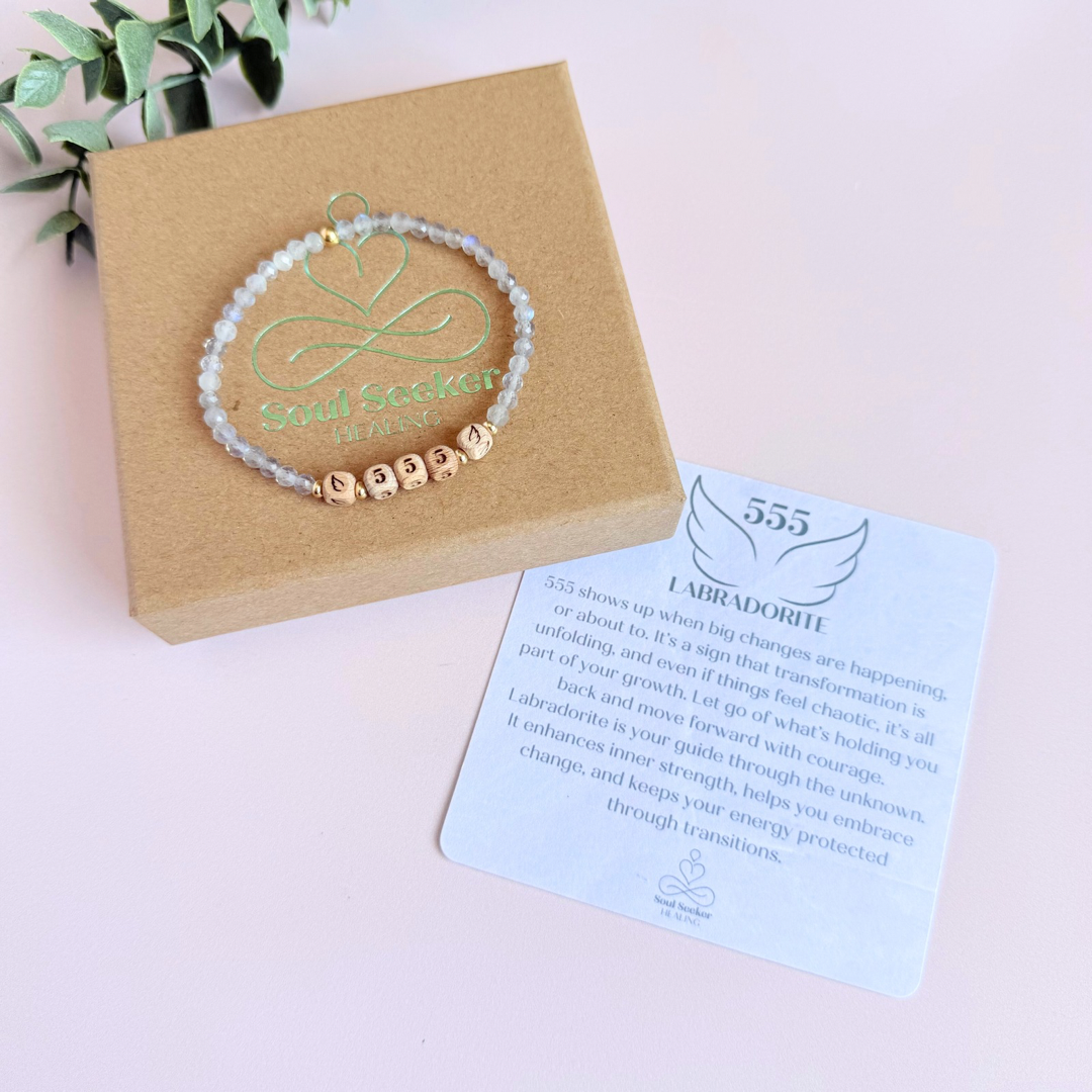 Bracelet featuring engraved wooden 555 angel number and wing beads, on the band of 4mm faceted labradorite round crystal gemstone beads. Finished with your choice of gold vermeil, sterling silver or rose gold vermeil accent beads.