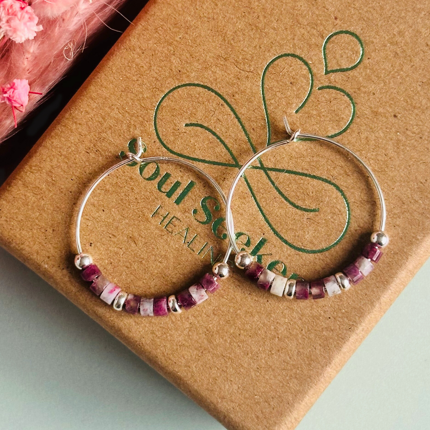 Pink tourmaline sterling silver hoop earrings made with pink tourmaline heishi beads on 25mm sterling silver hoops.