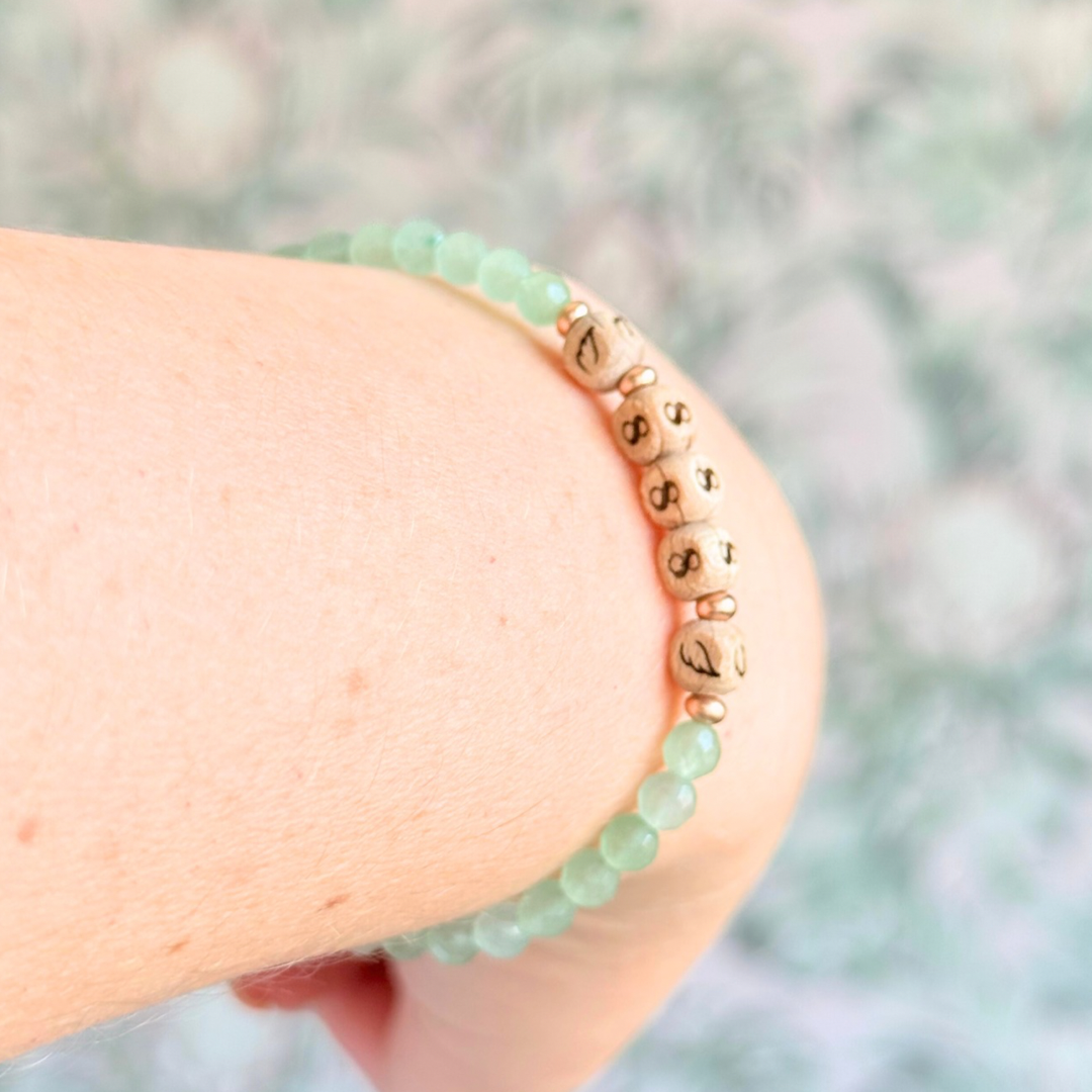 Bracelet featuring engraved wooden 888 angel number and wing beads, on the band of 4mm faceted green aventurine round crystal gemstone beads. Finished with your choice of gold vermeil, sterling silver or rose gold vermeil accent beads.