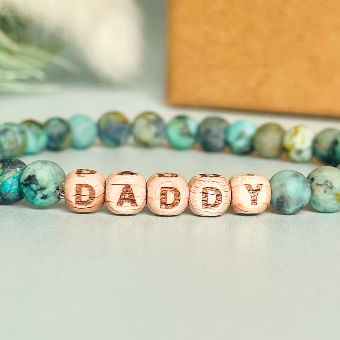 Men’s crystal bracelet with 6mm frosted African turquoise gemstone crystal beads and laser engraved wooden letter beads featuring the words best dad or can also be made with any other words or letters.