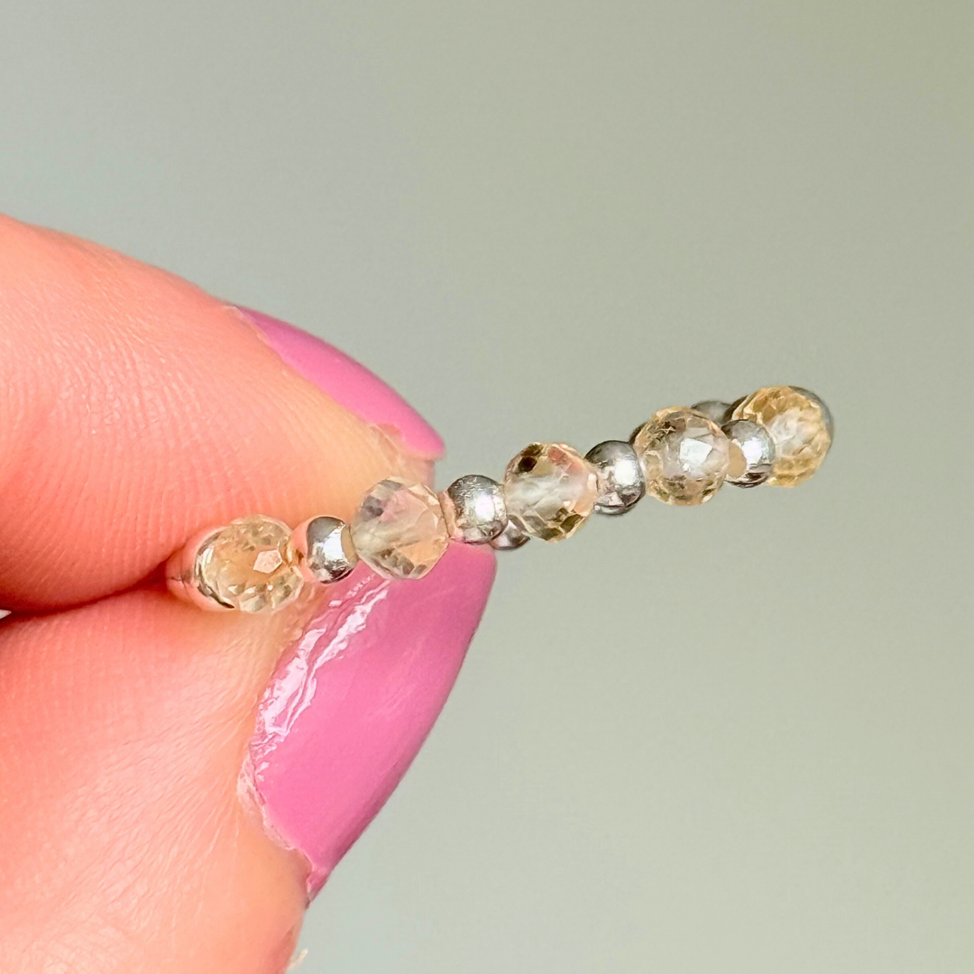 Sterling silver and citrine crystal ring. Made with 2.5mm sterling silver round beads and featuring five, 3mm faceted genuine citrine beads in a band style. Perfect for stacking. November birthstone jewellery