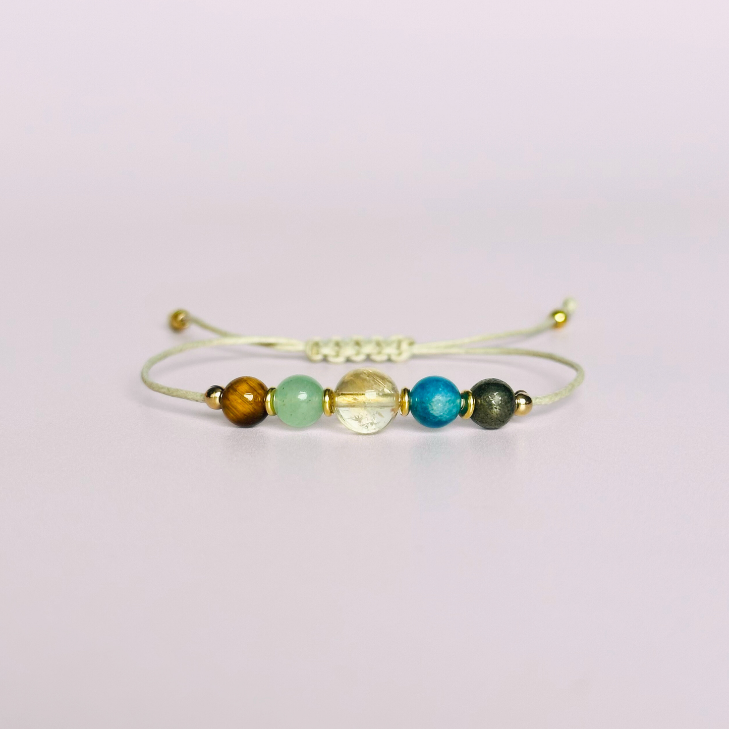 Manifesting crystal healing bracelet made with the tigers eye, green aventurine, citrine, apatite and pyrite. Strung on an eco and vegan friendly waxed cotton cord and finished with your choice of sterling silver, rose gold vermeil or gold vermeil accent beads. A sliding macramé clasp makes it adjustable.