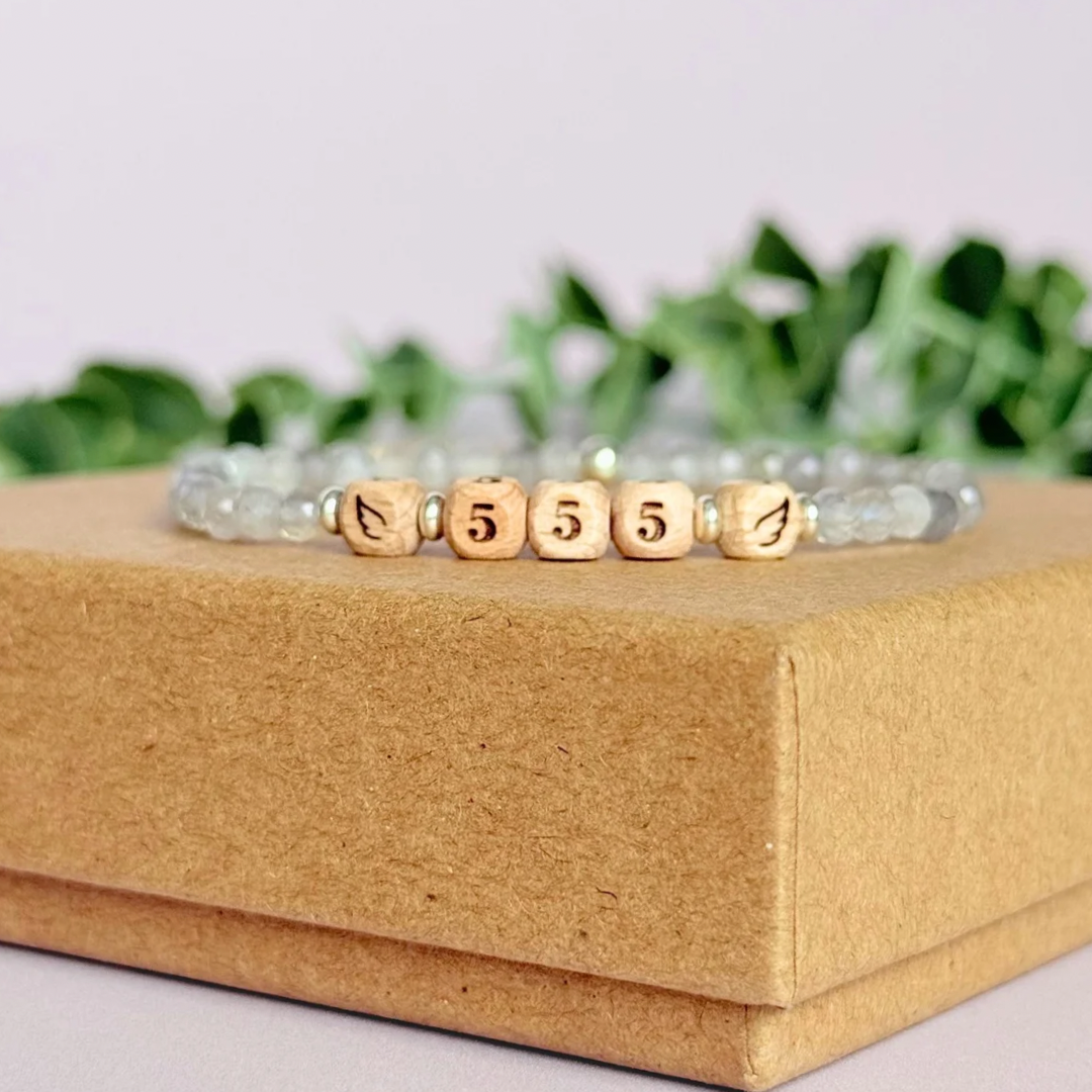 Bracelet featuring engraved wooden 555 angel number and wing beads, on the band of 4mm faceted labradorite round crystal gemstone beads. Finished with your choice of gold vermeil, sterling silver or rose gold vermeil accent beads.