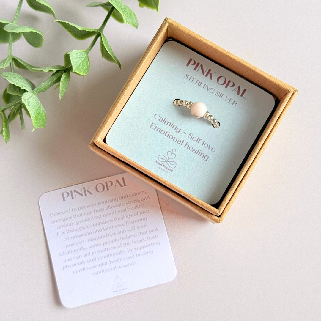 Sterling silver pink opal October birthstone ring featuring a 6mm smooth, round pink opal bead on a band of 2.5mm sterling silver ball beads. Elasticated for comfort.