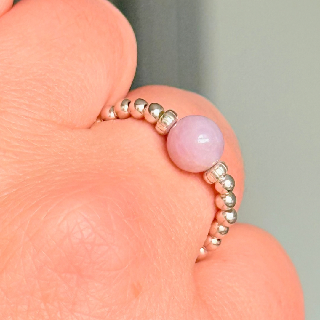 Crystal ring with a 6mm kunzite round bead on an elasticated ring band of 2.5mm sterling silver ball beads.
