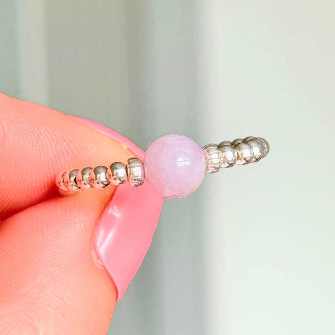Crystal ring with a 6mm kunzite round bead on an elasticated ring band of 2.5mm sterling silver ball beads.