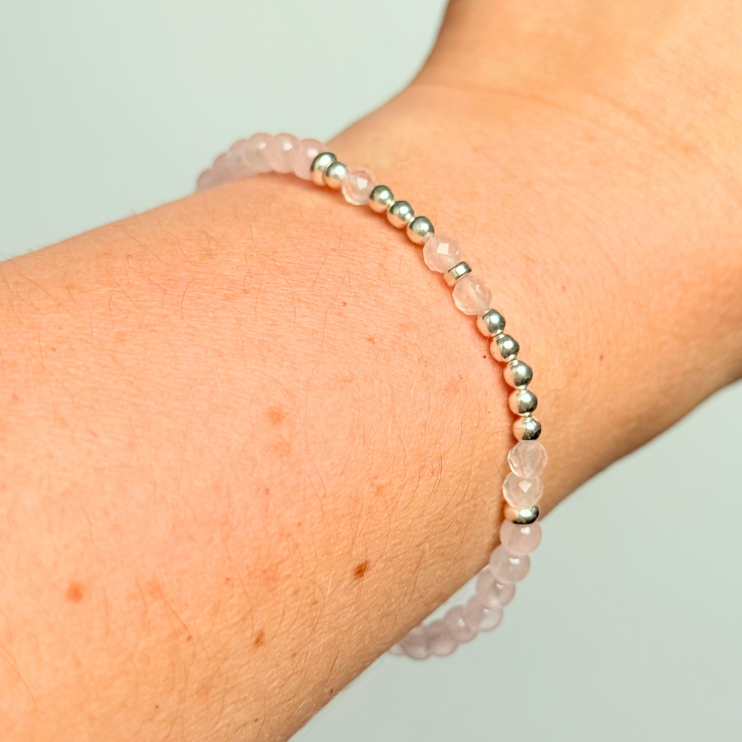 Rose quartz crystal morse code bracelet that spells out the words ‘Let them’ in a combination of 4mm round rose quartz beads, 4mm faceted rose quartz beads and either sterling silver or gold vermeil 3mm round beads. The words start and end at the rondelle spacer beads.