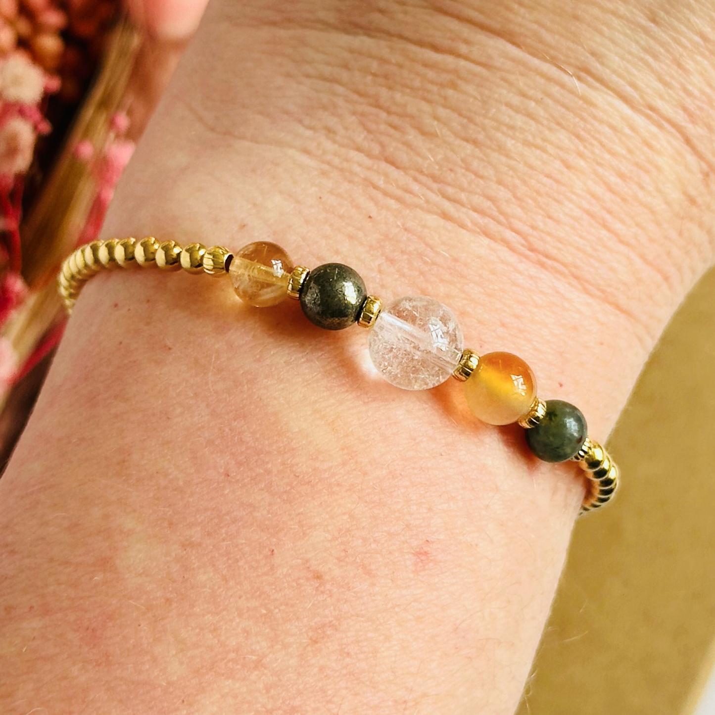 This gold vermeil Aries bracelet is made with a selection of five healing crystals all believed to resonate with the Aries zodiac sign. The central bead is 8mm, the other four are 6mm. On an elasticated band of 3mm gold vermeil beads with corrugated accent beads. Featuring citrine, bloodstone, carnelian, pyrite and clear quartz.