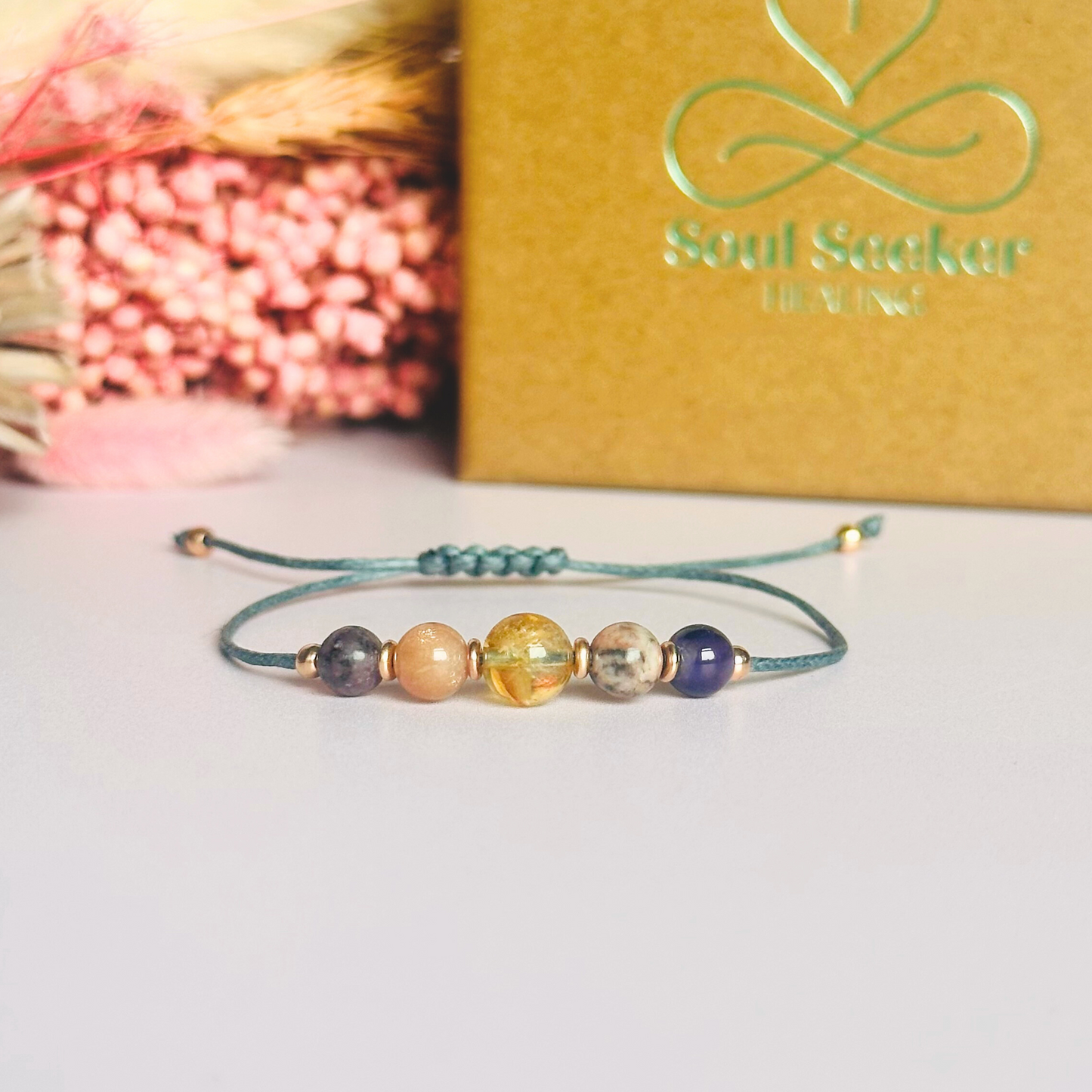 Menopause crystal healing bracelet made with the lepidolite, peach moonstone, citrine, pink zebra jasper and amethyst. Strung on an eco and vegan friendly waxed cotton cord and finished with your choice of sterling silver, rose gold vermeil or gold vermeil accent beads. A sliding macramé clasp makes it adjustable.