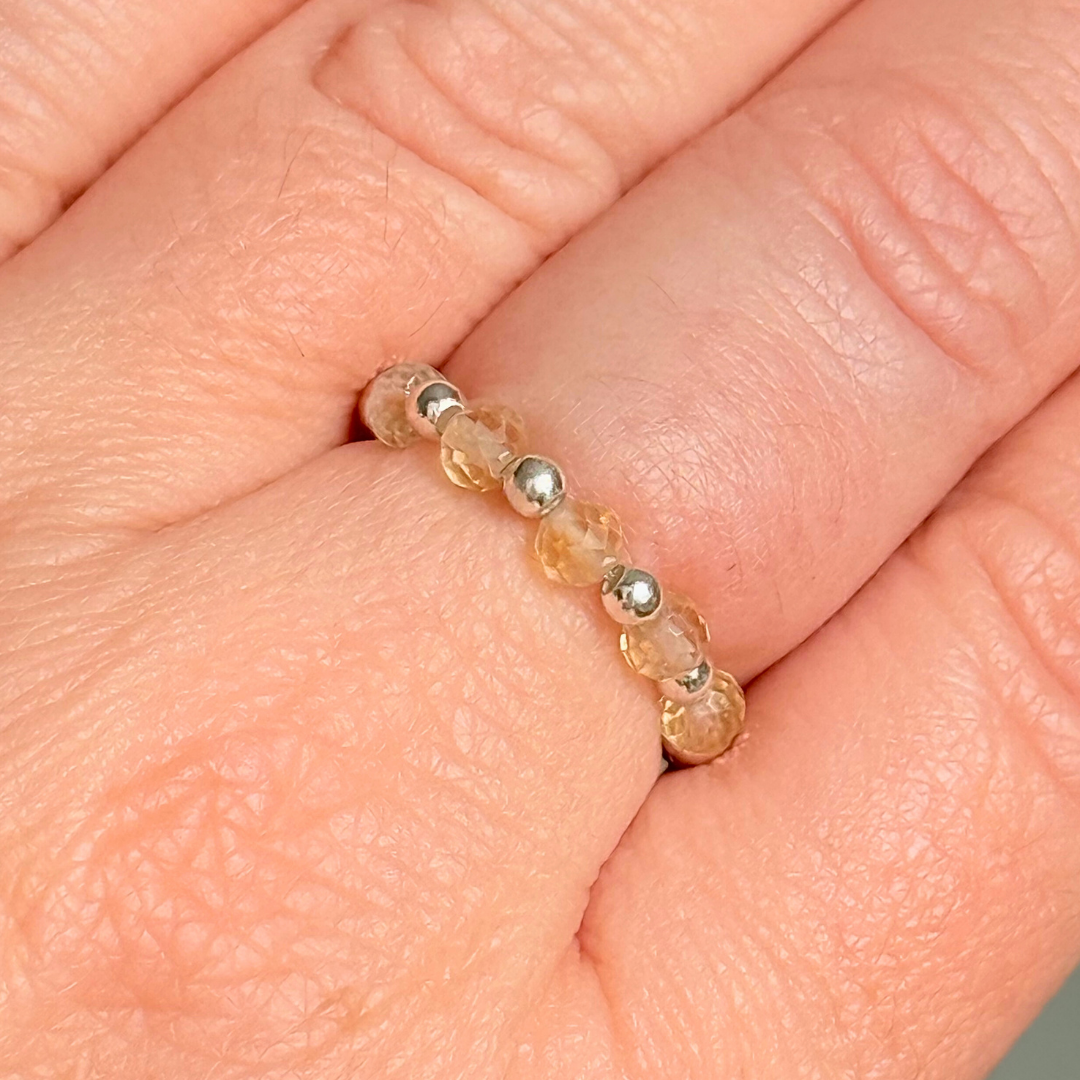 Sterling silver and citrine crystal ring. Made with 2.5mm sterling silver round beads and featuring five, 3mm faceted genuine citrine beads in a band style. Perfect for stacking. November birthstone jewellery