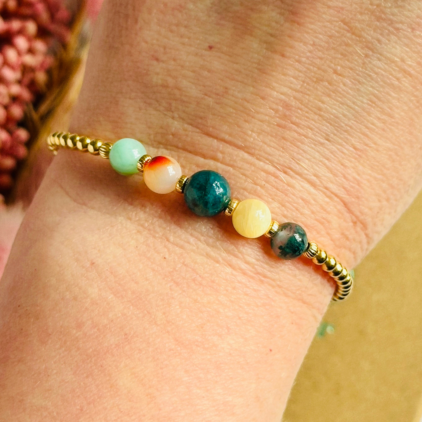 This gold vermeil Gemini bracelet is made with a selection of five healing crystals all believed to resonate with the Gemini zodiac sign. The central bead is 8mm, the other four are 6mm. On an elasticated band of 3mm gold vermeil beads with corrugated accent beads. Featuring chrysocolla, dendritic agate, apatite, yellow calcite and moss agate.