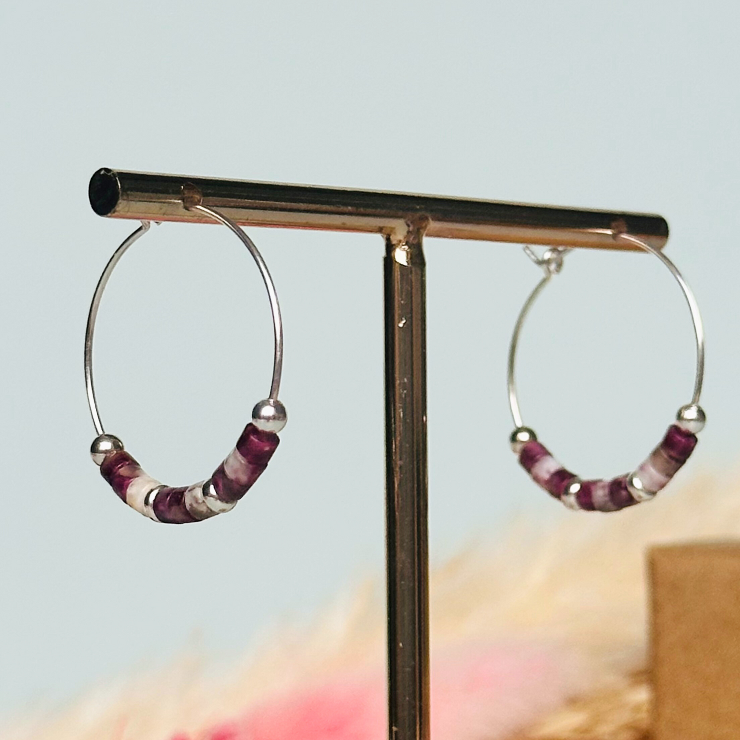 Pink tourmaline sterling silver hoop earrings made with pink tourmaline heishi beads on 25mm sterling silver hoops.