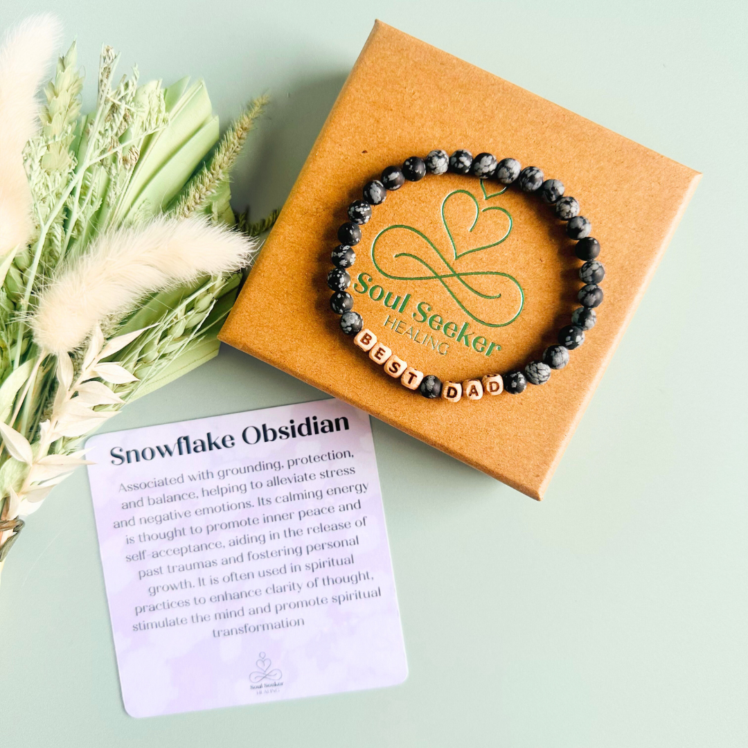 Men’s crystal bracelet with 6mm frosted snowflake obsidian gemstone crystal beads and laser engraved wooden letter beads featuring the word best dad or can also be made with any other words or letters.
