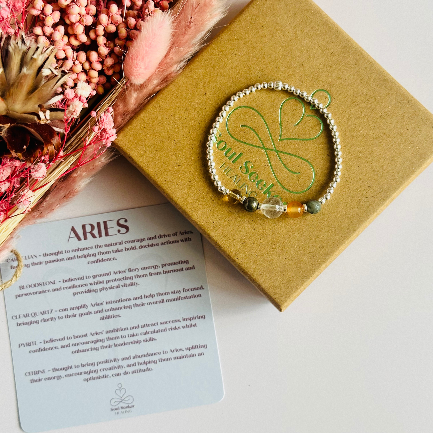 This sterling silver Aries bracelet is made with a selection of five healing crystals all believed to resonate with the Aries zodiac sign. The central bead is 8mm, the other four are 6mm. On an elasticated band of 3mm sterling silver beads with corrugated accent beads. Featuring carnelian, bloodstone, pyrite, clear quartz and citrine.