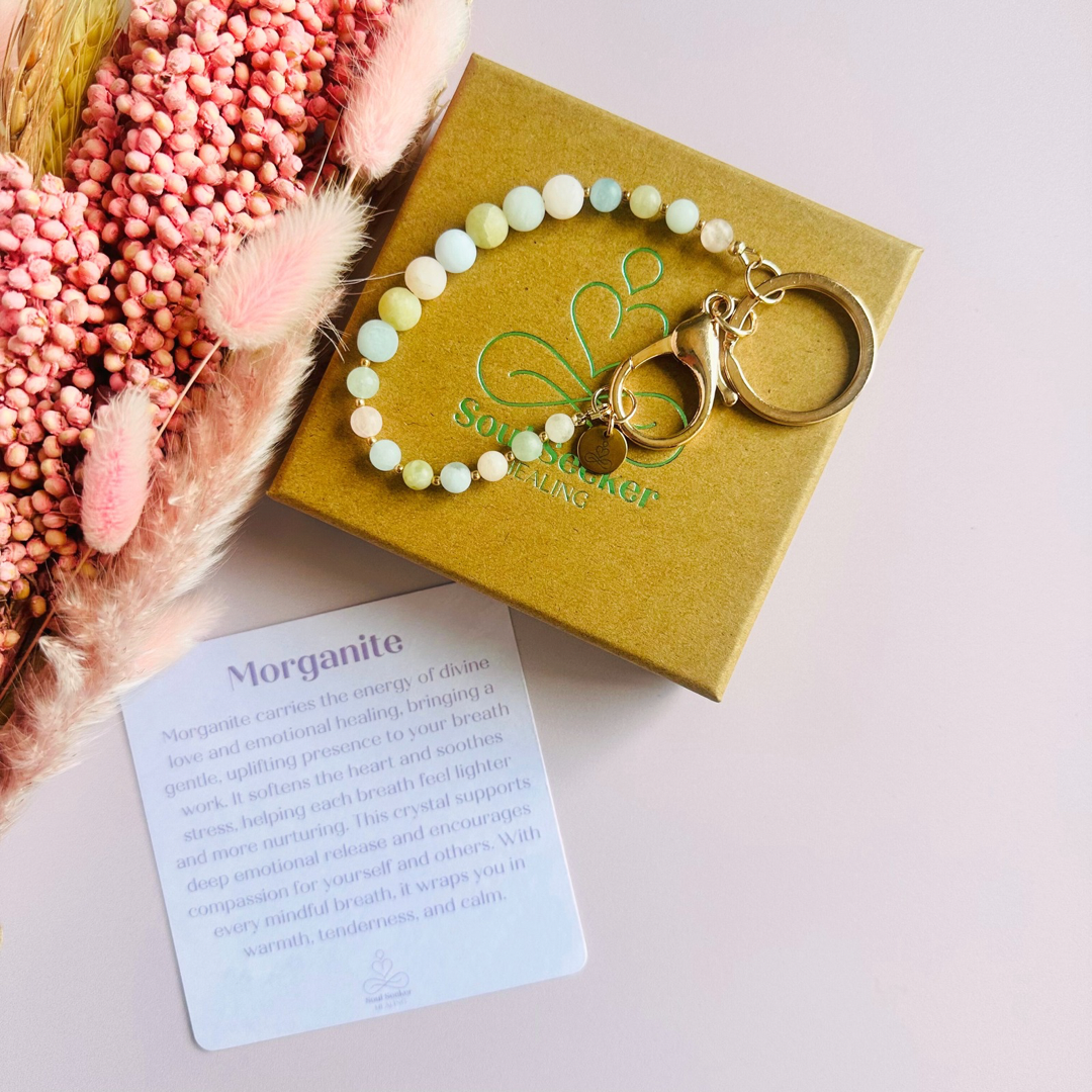 Frosted morganite breath work beads on a rose gold keychain/bag charm. For the 4-7-8 counted breathing method.