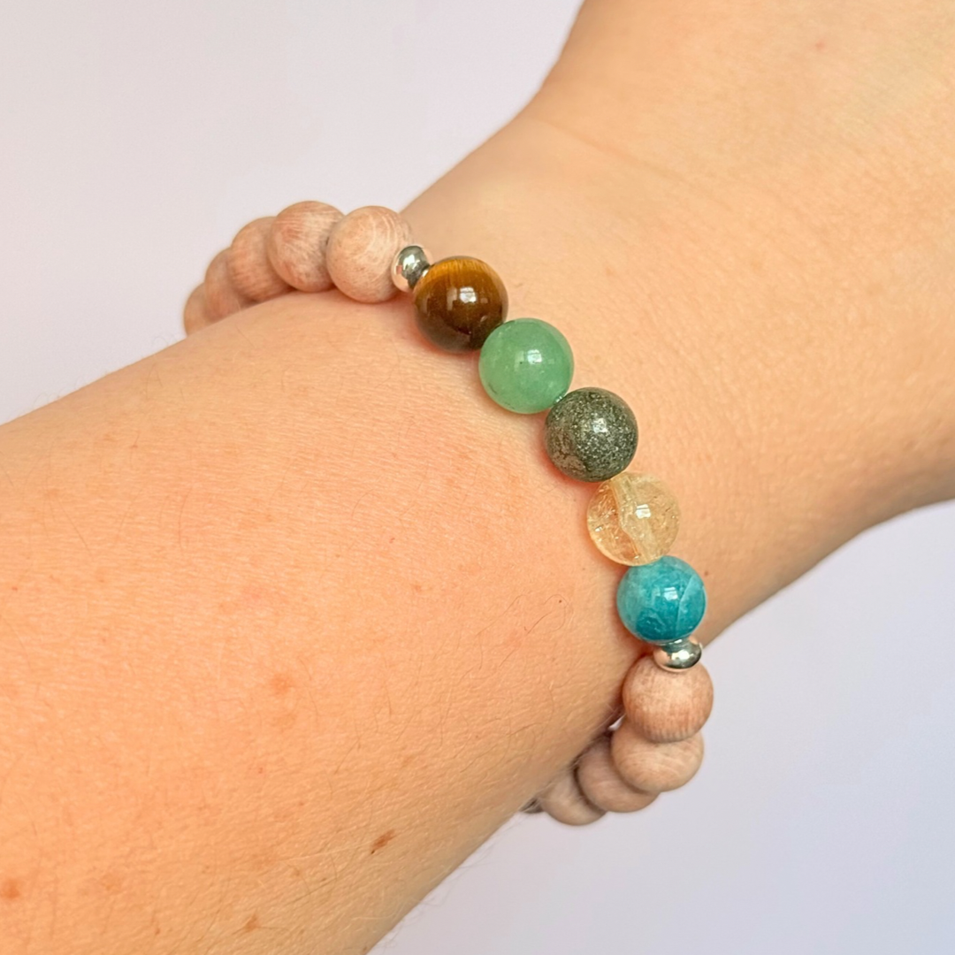 Essential oil diffuser bracelet with five crystals all believed to help with manifestation. Featuring raw rosewood beads to diffuse aromatherapy oils. With apatite, citrine, pyrite, green aventurine and tigers eye. All beads are 8 mm.