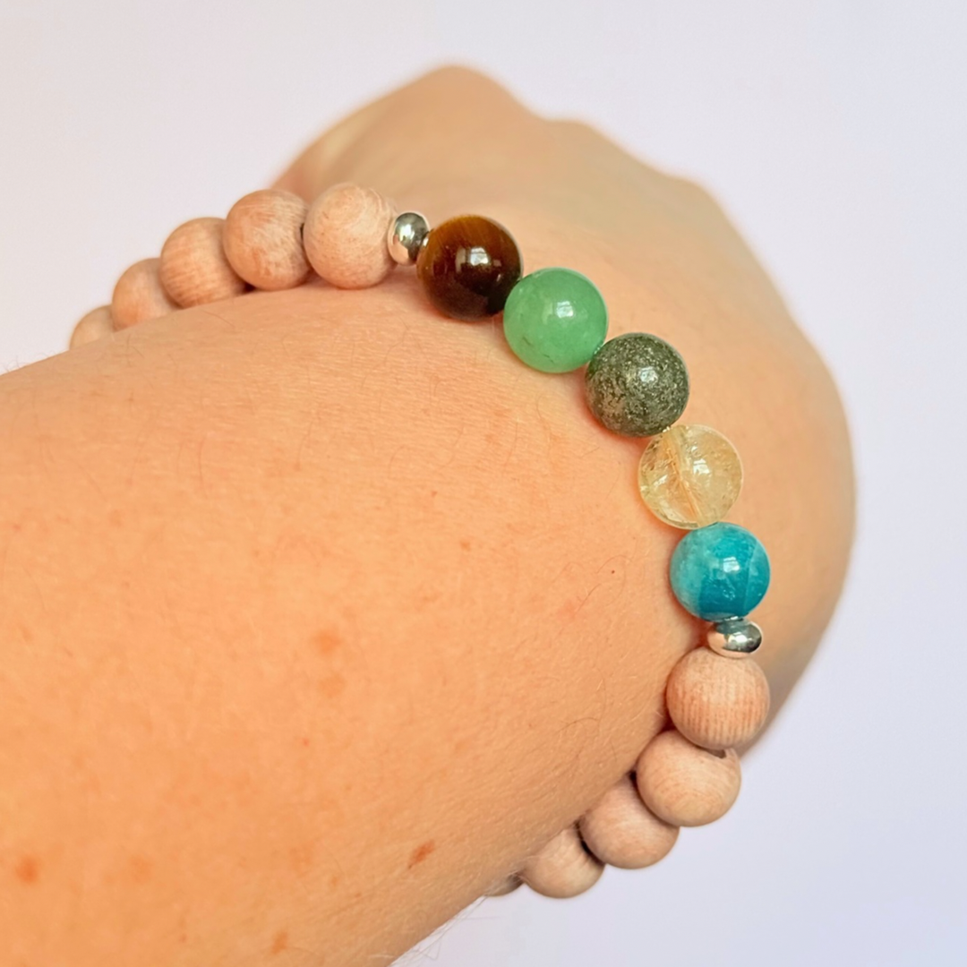 Essential oil diffuser bracelet with five crystals all believed to help with manifestation. Featuring raw rosewood beads to diffuse aromatherapy oils. With apatite, citrine, pyrite, green aventurine and tigers eye. All beads are 8 mm.
