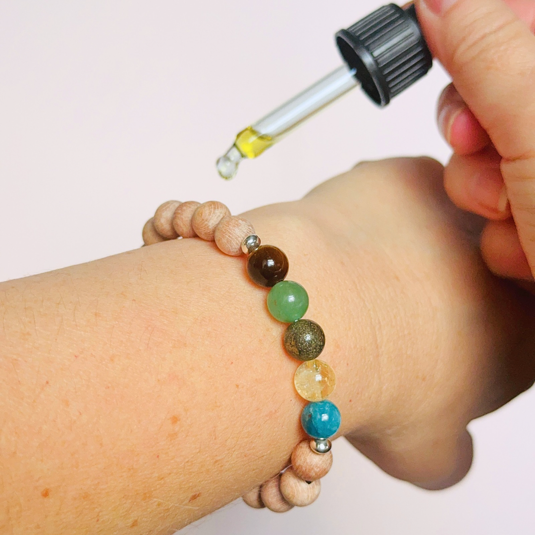 Essential oil diffuser bracelet with five crystals all believed to help with manifestation. Featuring raw rosewood beads to diffuse aromatherapy oils. With apatite, citrine, pyrite, green aventurine and tigers eye. All beads are 8 mm.