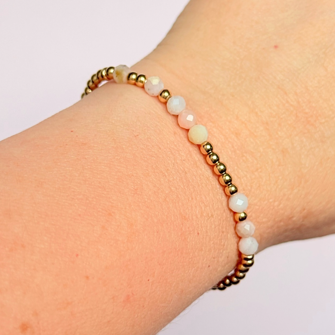 Morse code secret message bracelet spelling out your chosen name in gold filled and pink opal crystal beads. Elasticated with 4mm faceted pink opal beads and 3mm gold filled beads. Custom October birthstone bracelet.