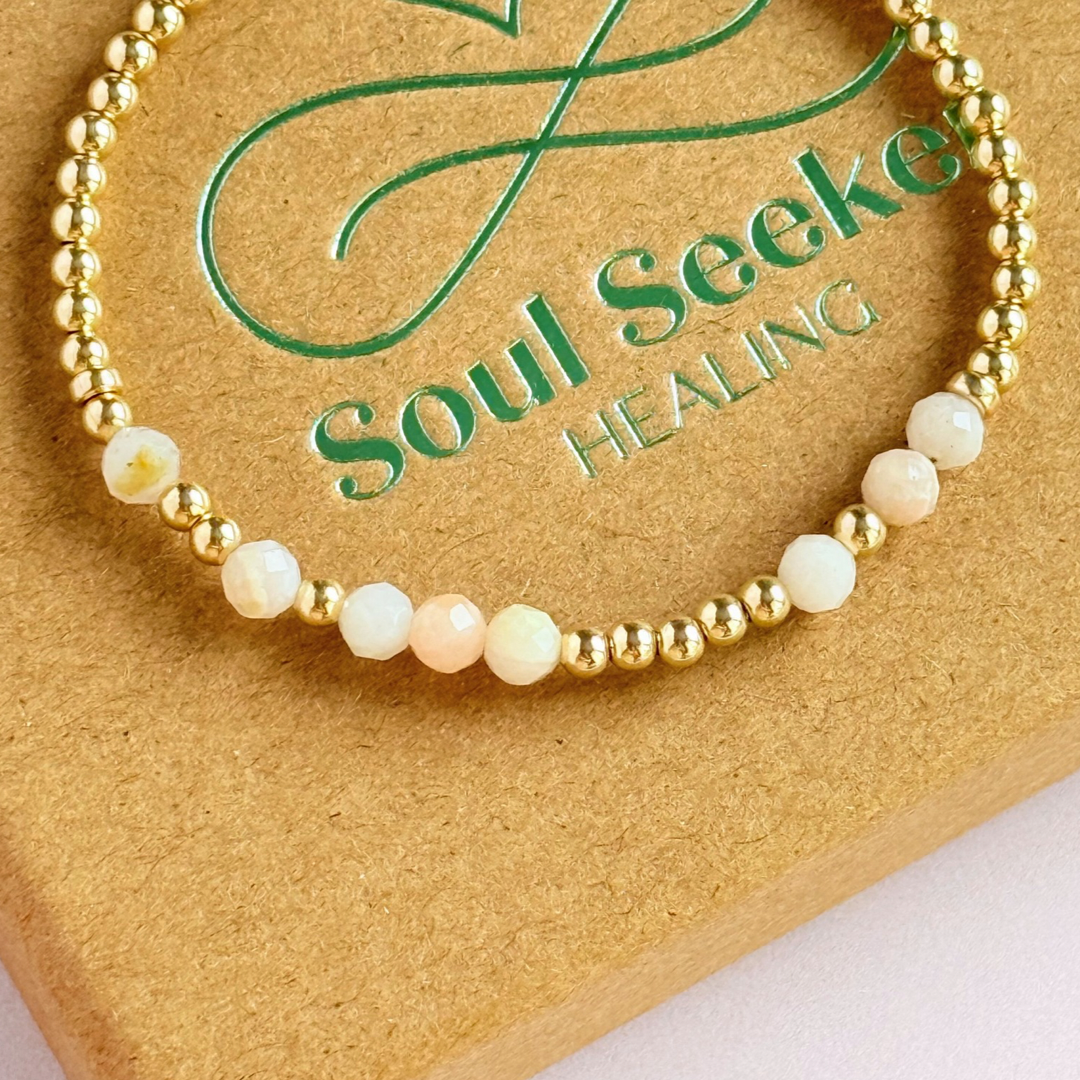 Morse code secret message bracelet spelling out your chosen name in gold filled and pink opal crystal beads. Elasticated with 4mm faceted pink opal beads and 3mm gold filled beads. Custom October birthstone bracelet.