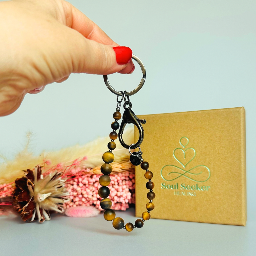 Frosted tigers eye breath work beads on a black plated keychain/bag charm. For the 4-7-8 counted breathing method.