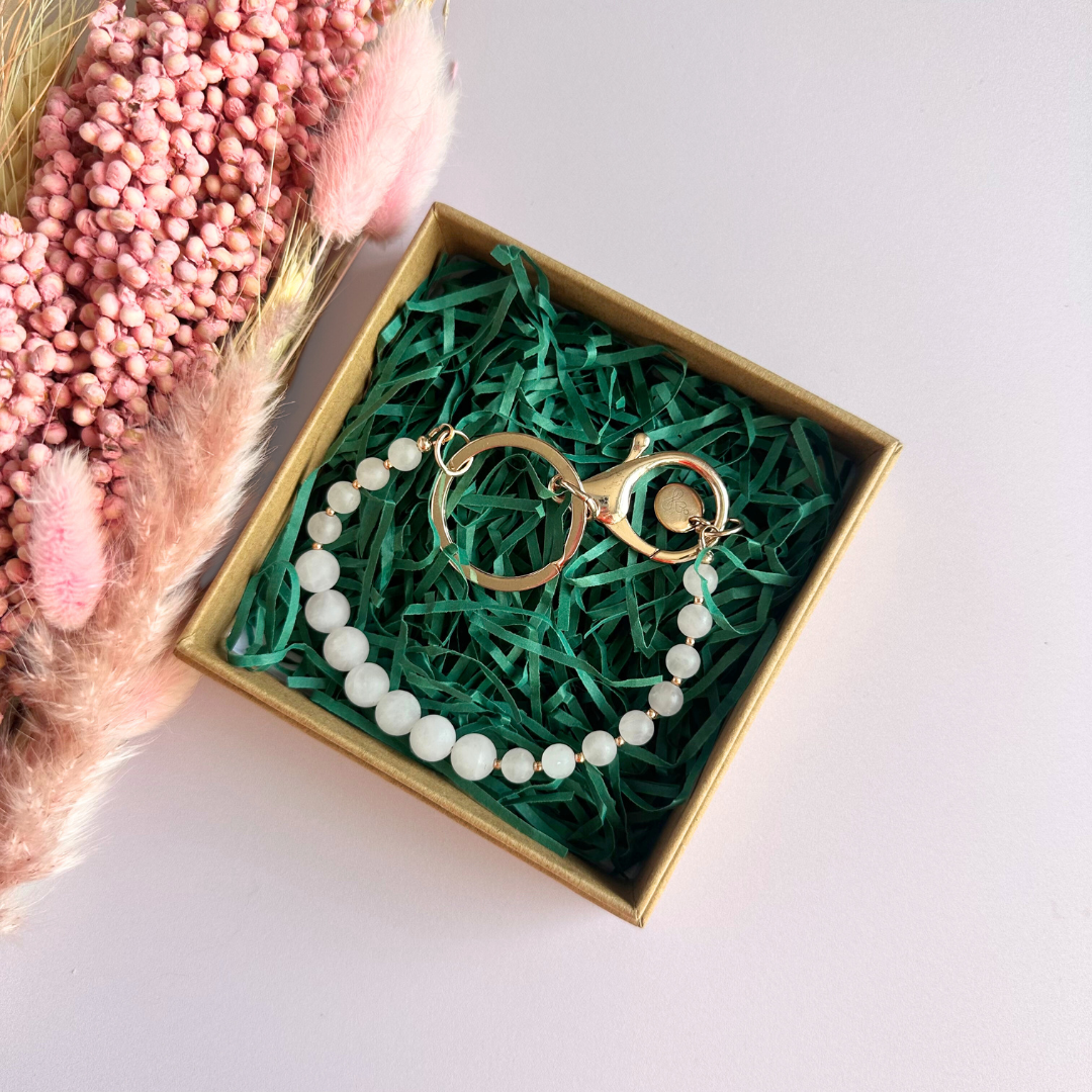 Frosted rose quartz breath work beads on a rose gold keychain/bag charm. For the 4-7-8 counted breathing method.