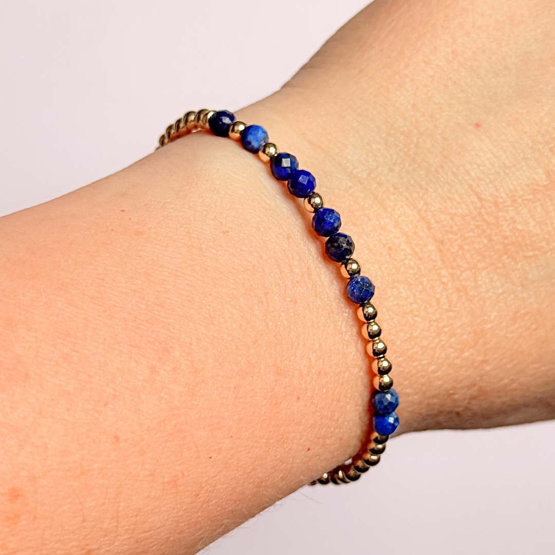 Morse code secret message bracelet spelling out your chosen name in gold filled and lapis lazuli crystal beads. Elasticated with 4mm faceted lapis lazuli beads and 3mm gold filled beads. Custom September birthstone bracelet.