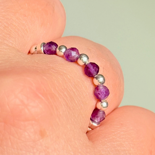 Sterling silver amethyst ring featuring five 3mm faceted round amethyst beads on a elasticated ring band of 2.5mm sterling silver beads. February birthstone ring.