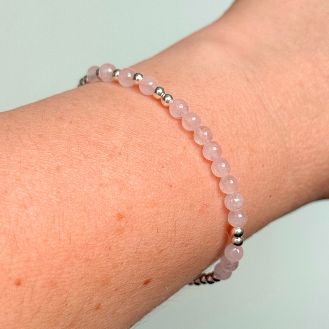 Morse code secret message bracelet spelling out the words Mum est. 2025 in sterling silver and rose quartz crystal beads. elasticated with 4mm rose quartz beads and 3mm sterling silver beads.
