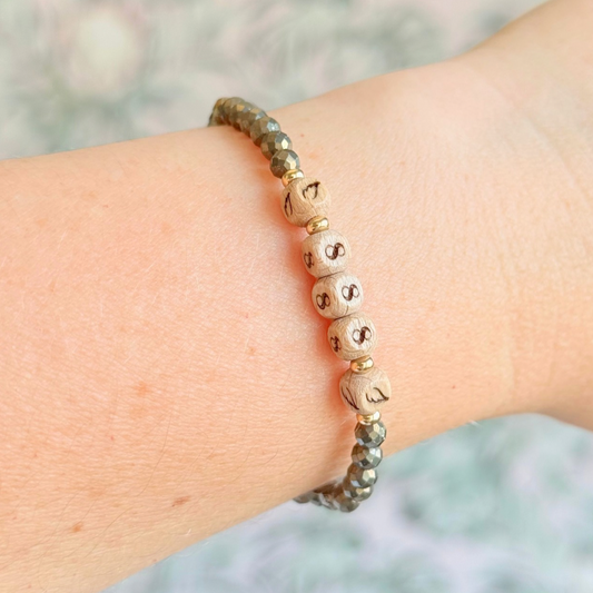 Bracelet featuring engraved wooden 888 angel number and wing beads, on the band of 4mm faceted pyrite round crystal gemstone beads. Finished with your choice of gold vermeil, sterling silver or rose gold vermeil accent beads.