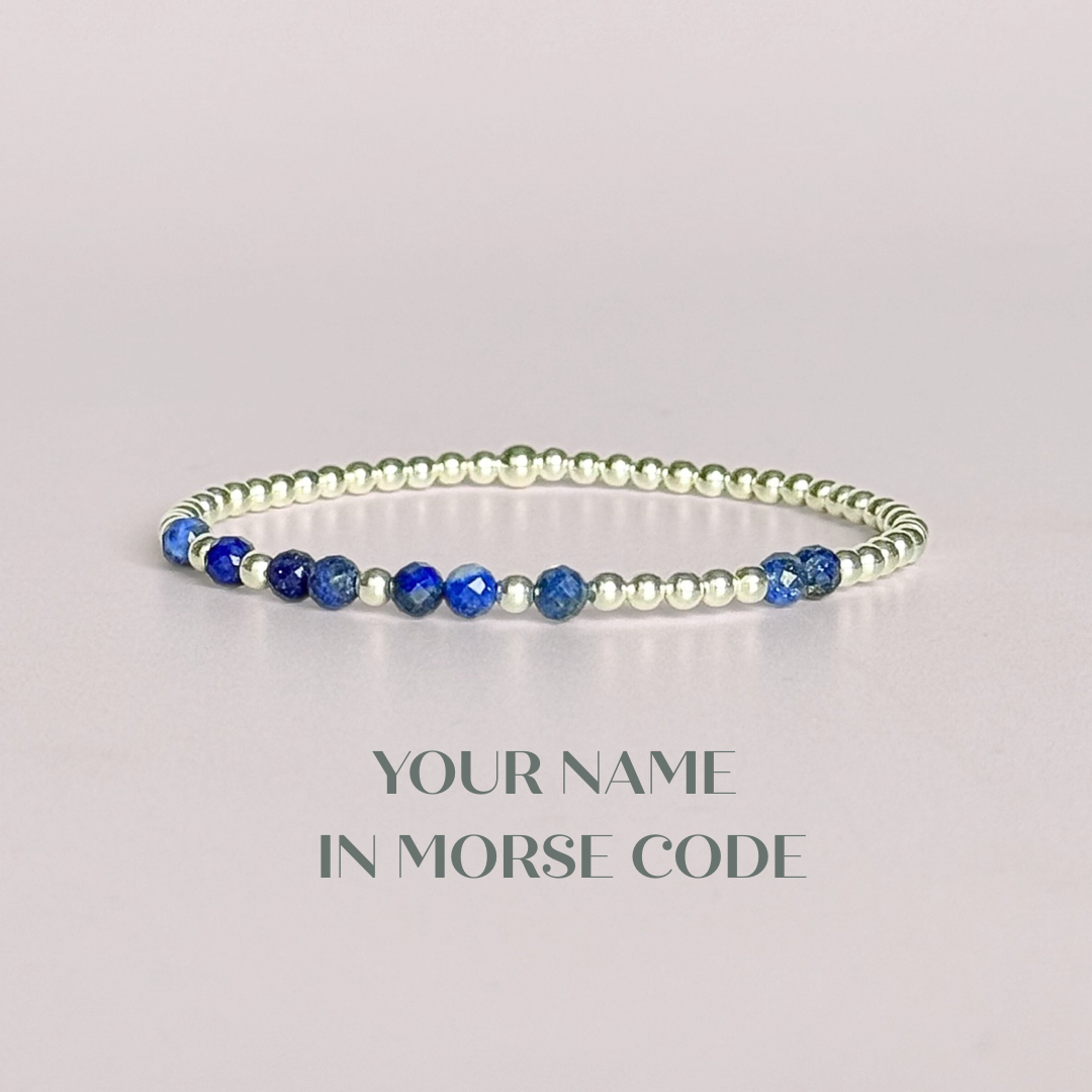 Morse code secret message bracelet spelling out your chosen name in sterling silver and lapis lazuli crystal beads. Elasticated with 4mm faceted lapis lazuli beads and 3mm sterling silver beads. Custom September birthstone bracelet.