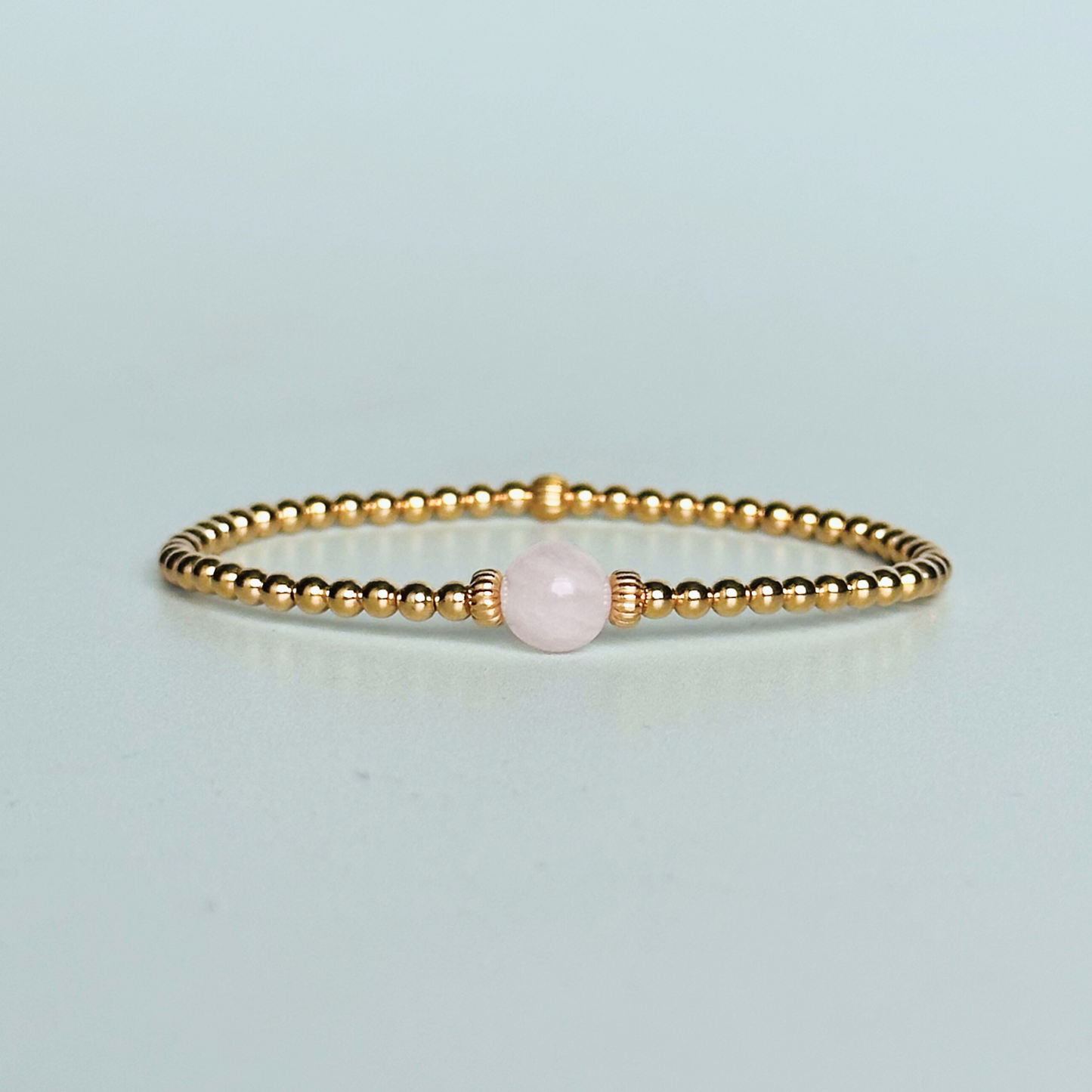 Gold vermeil rose quartz  bracelet features an ethically mined 8mm rose quartz bead, flanked by corrugated rondelle beads on a band of 3mm gold vermeil beads. A bracelet to promote self love and self-confidence.