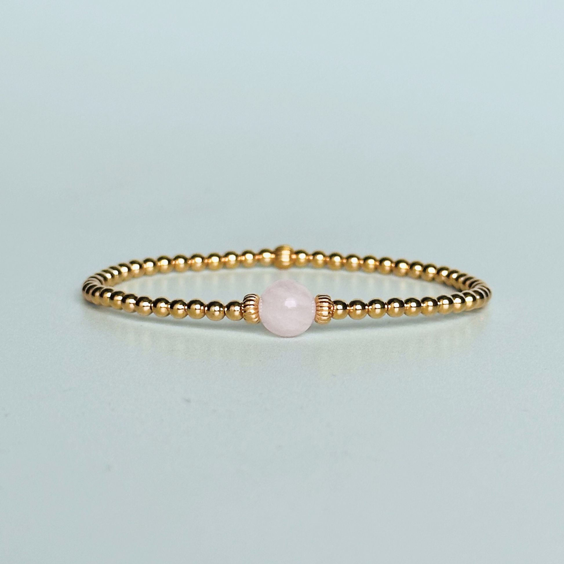 Gold vermeil rose quartz  bracelet features an ethically mined 8mm rose quartz bead, flanked by corrugated rondelle beads on a band of 3mm gold vermeil beads. A bracelet to promote self love and self-confidence.