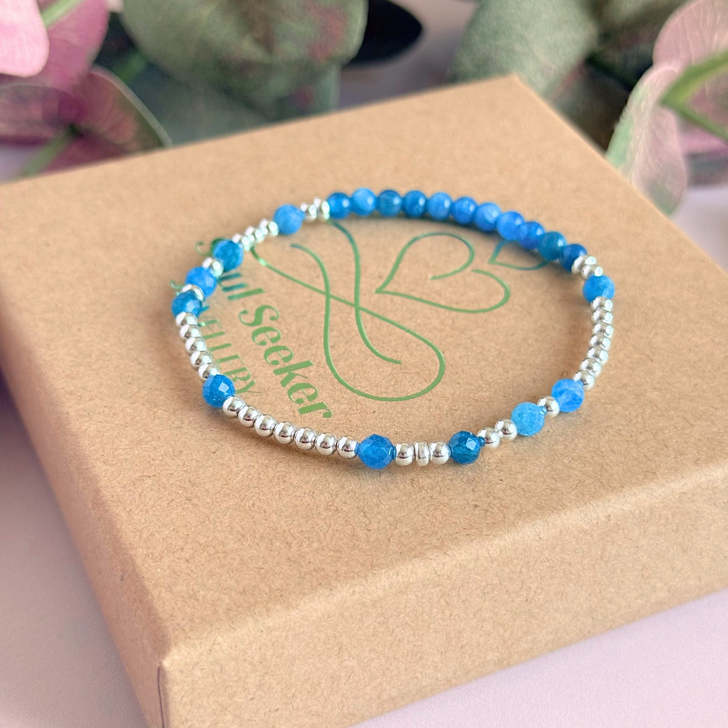 Apatite morse code bracelet that spells out the words ‘Ask, believe, receive’ in a combination of 4mm round smooth and faceted crystal beads with your choice of sterling silver or gold vermeil accent beads. Pictured in silver, on the gift box