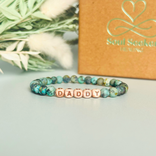 Men’s crystal bracelet with 6mm frosted African turquoise gemstone crystal beads and laser engraved wooden letter beads featuring the words best dad or can also be made with any other words or letters.