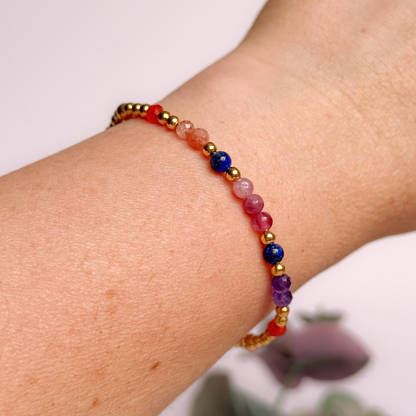 ‘Arabian Sunset' gold vermeil dainty beaded bracelet with pink tourmaline, sunstone, carnelian, lapis lazuli and amethyst. Made with round 3mm gold vermeil beads and 4mm smooth and faceted round crystal gemstone beads. Pictured being worn