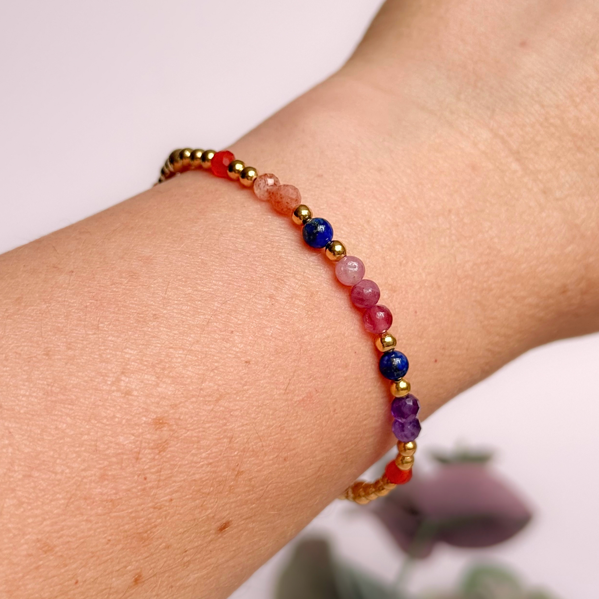 ‘Arabian Sunset' gold vermeil dainty beaded bracelet with pink tourmaline, sunstone, carnelian, lapis lazuli and amethyst. Made with round 3mm gold vermeil beads and 4mm smooth and faceted round crystal gemstone beads. Pictured being worn